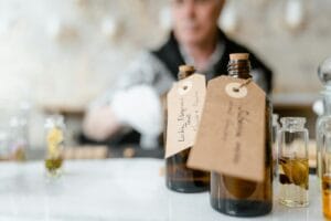 A collection of affordable perfumes that smell expensive, displayed on a marble countertop with elegant lighting.