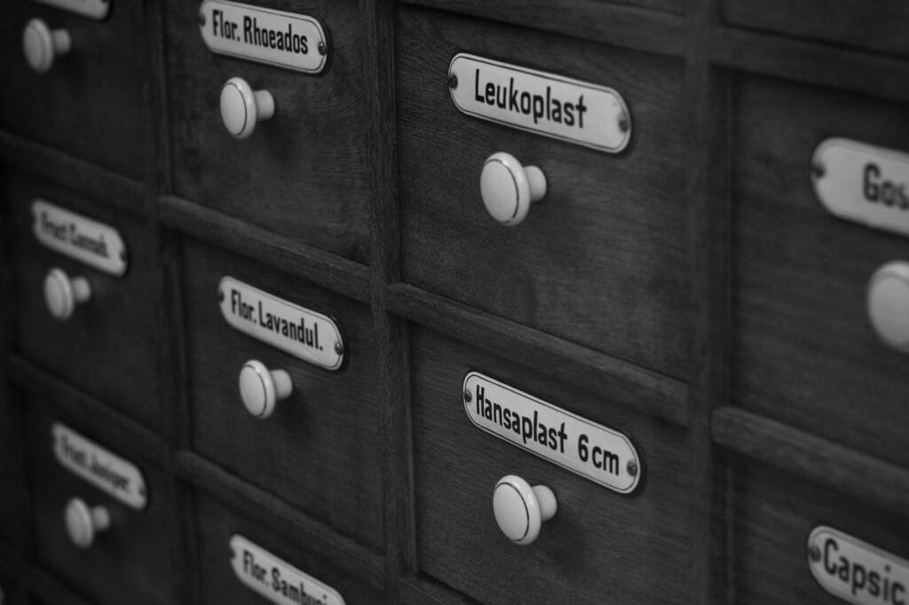 A collection of perfume bottles stored in a dark drawer to preserve their fragrance and longevity.
