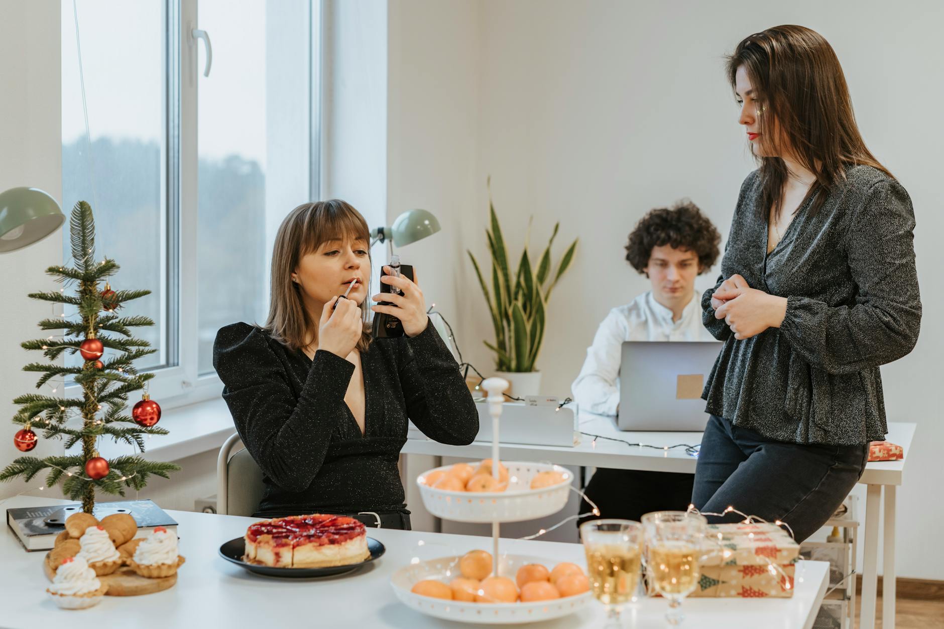 A professional woman in a modern office applying a subtle perfume to her wrist, representing the best office perfumes for women in 2026.
