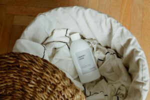 Collection of the best perfumes that smell like clean laundry, including luxury and affordable options, displayed with fresh linens and sunlight.