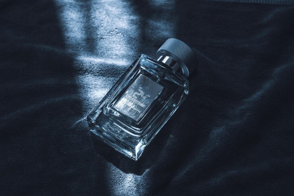 Collection of the best winter perfumes for men in 2026, including luxury and affordable options, displayed on a dark wooden table with snowflakes in the background.