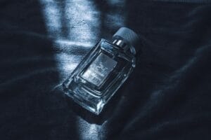 Collection of the best winter perfumes for men in 2026, including luxury and affordable options, displayed on a dark wooden table with snowflakes in the background.