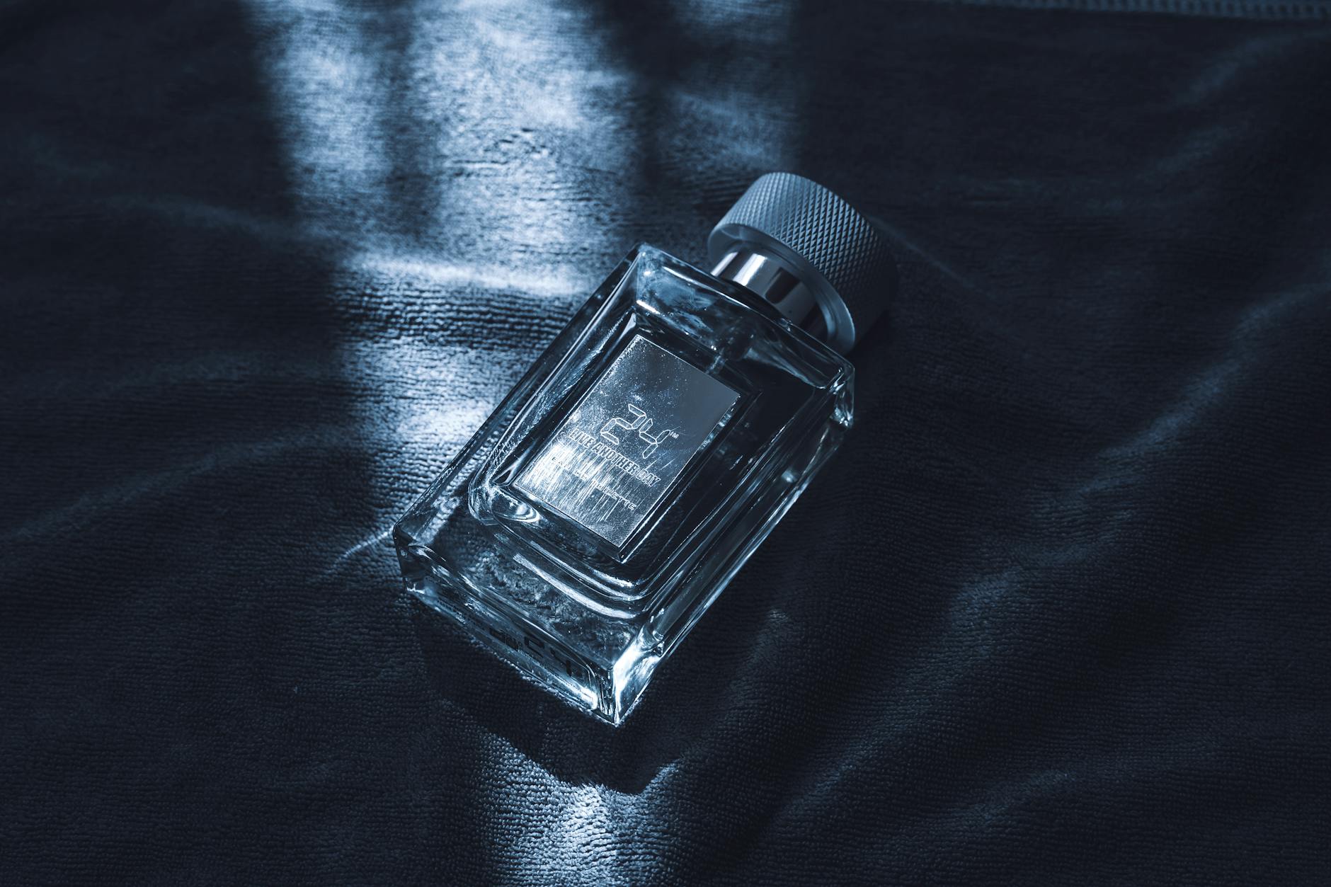 Collection of the best winter perfumes for men in 2026, including luxury and affordable options, displayed on a dark wooden table with snowflakes in the background.
