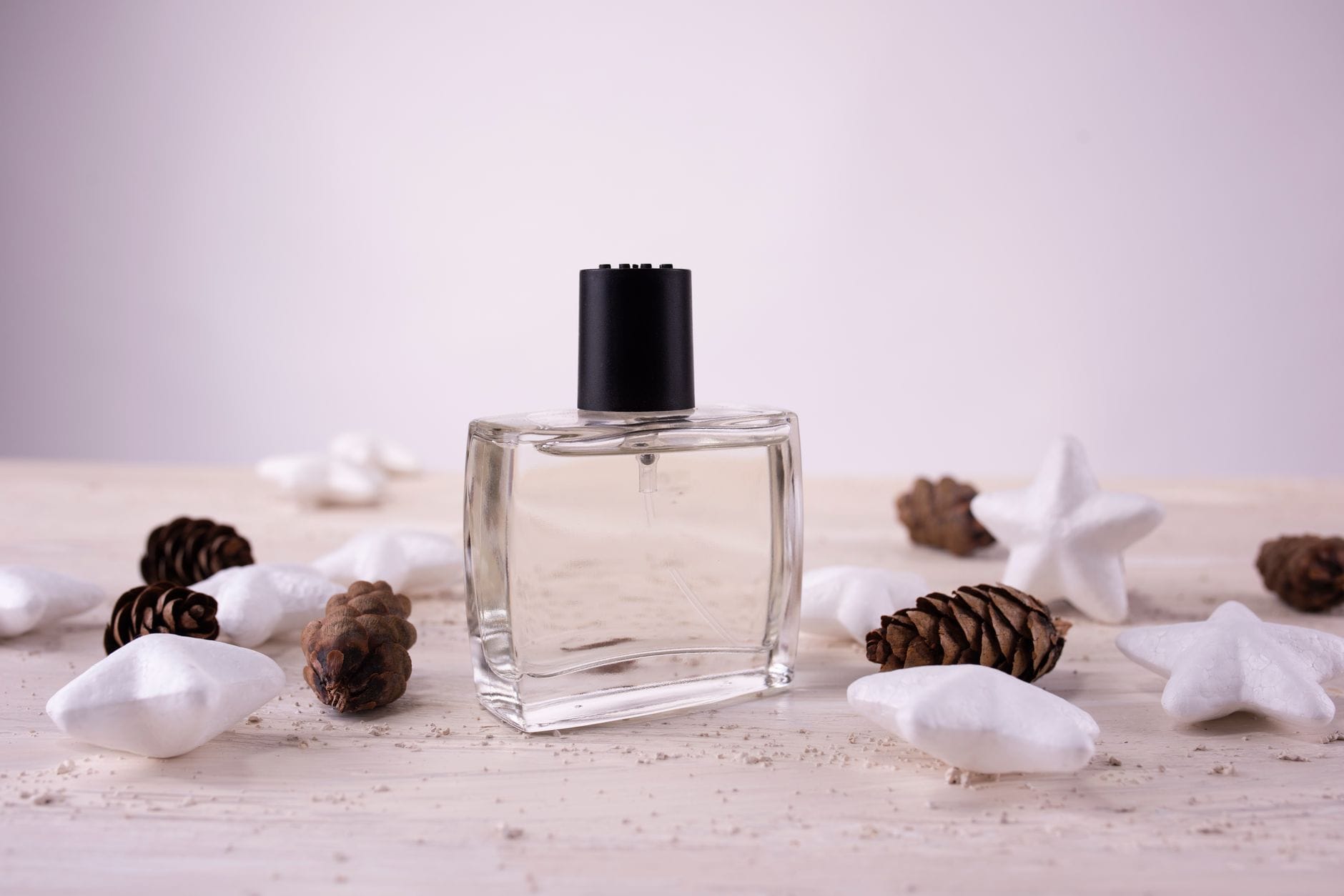 YSL Y EDP perfume bottle for men with fresh green apple and cedarwood notes, displayed on a wooden surface.