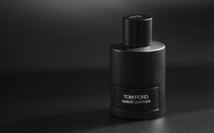 A collection of Tom Ford perfume bottles for men, including Oud Wood, Tobacco Vanille, and Noir Extreme, displayed on a dark luxury background.