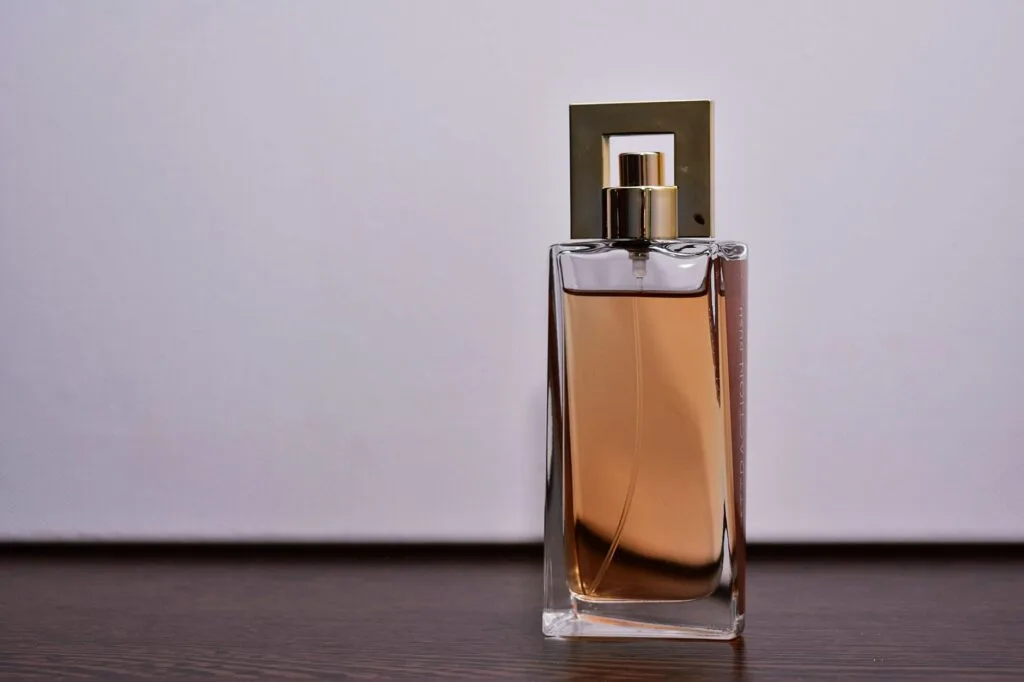 A collection of elegant perfume bottles on a marble surface, representing the process of choosing a signature scent.