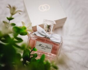 A collection of the best Dior perfumes of all time, including J’adore, Miss Dior, and Dior Sauvage, displayed on a marble surface.