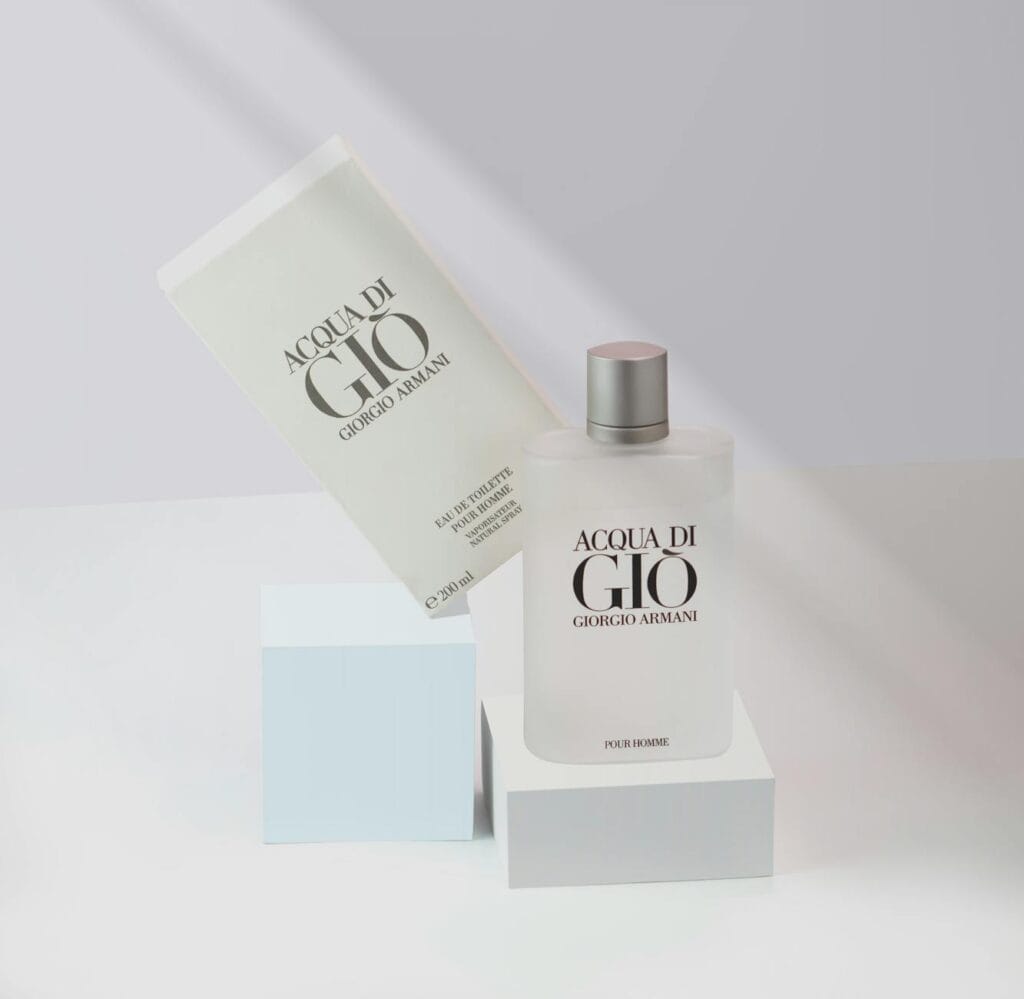 Armani Code perfume bottle with warm lighting and elegant models in the background, representing a luxury fragrance review.