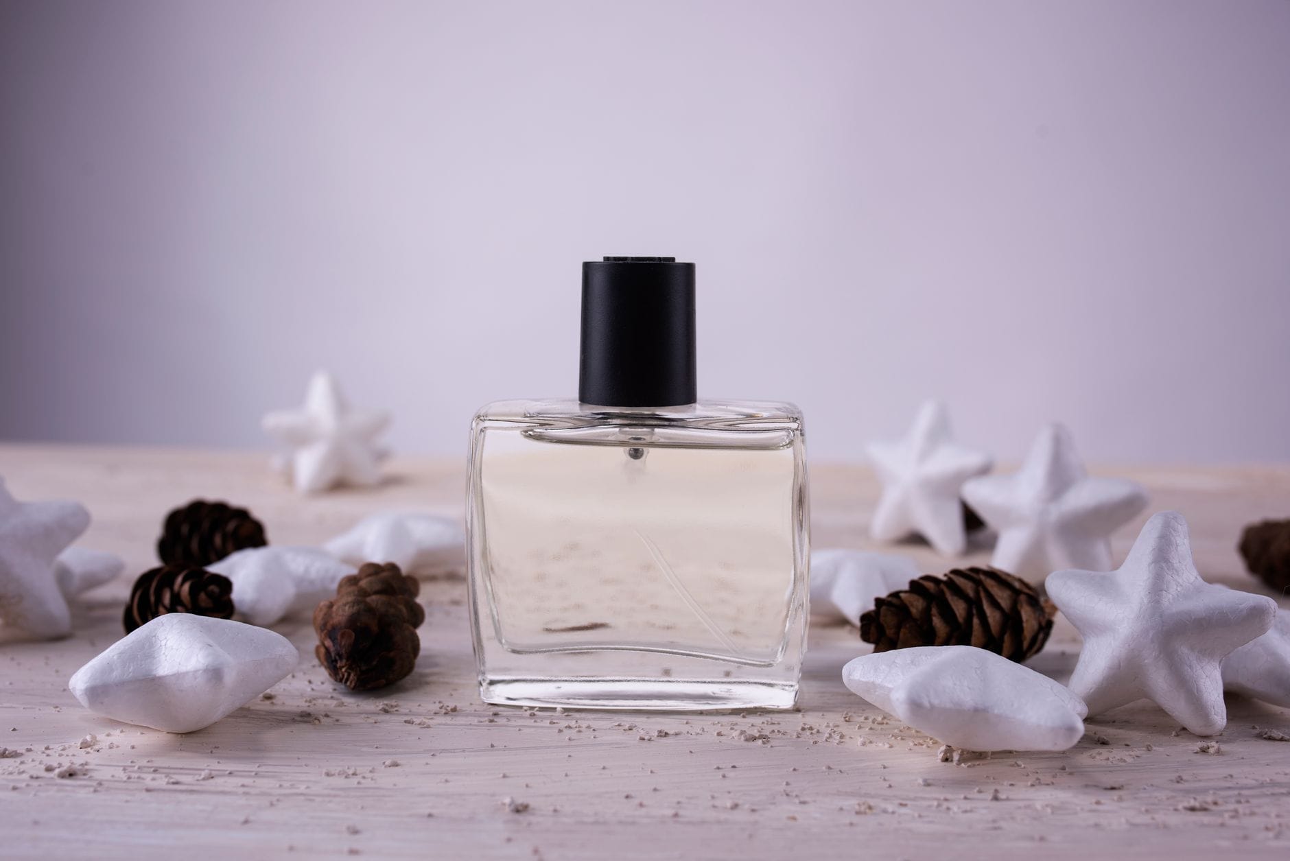 Prada Luna Rossa perfume bottle surrounded by fresh citrus fruits and lavender sprigs, representing its fresh aromatic scent profile.