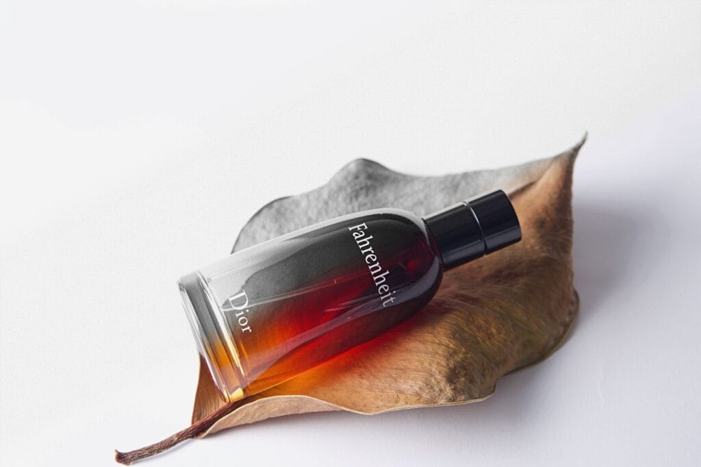 Top 10 best Dior perfumes for men in 2026, including Dior Sauvage EDP, Dior Homme Intense, and Dior Fahrenheit, displayed on a dark wooden table with elegant lighting.