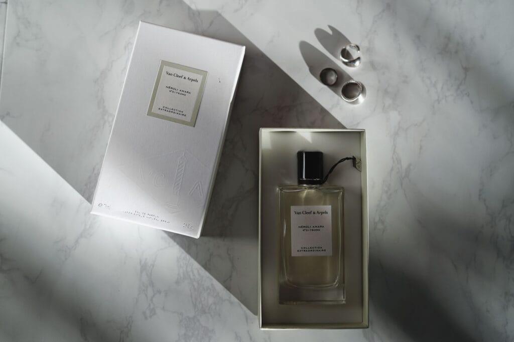 A collection of luxury niche perfume bottles from top brands displayed on an elegant marble surface.