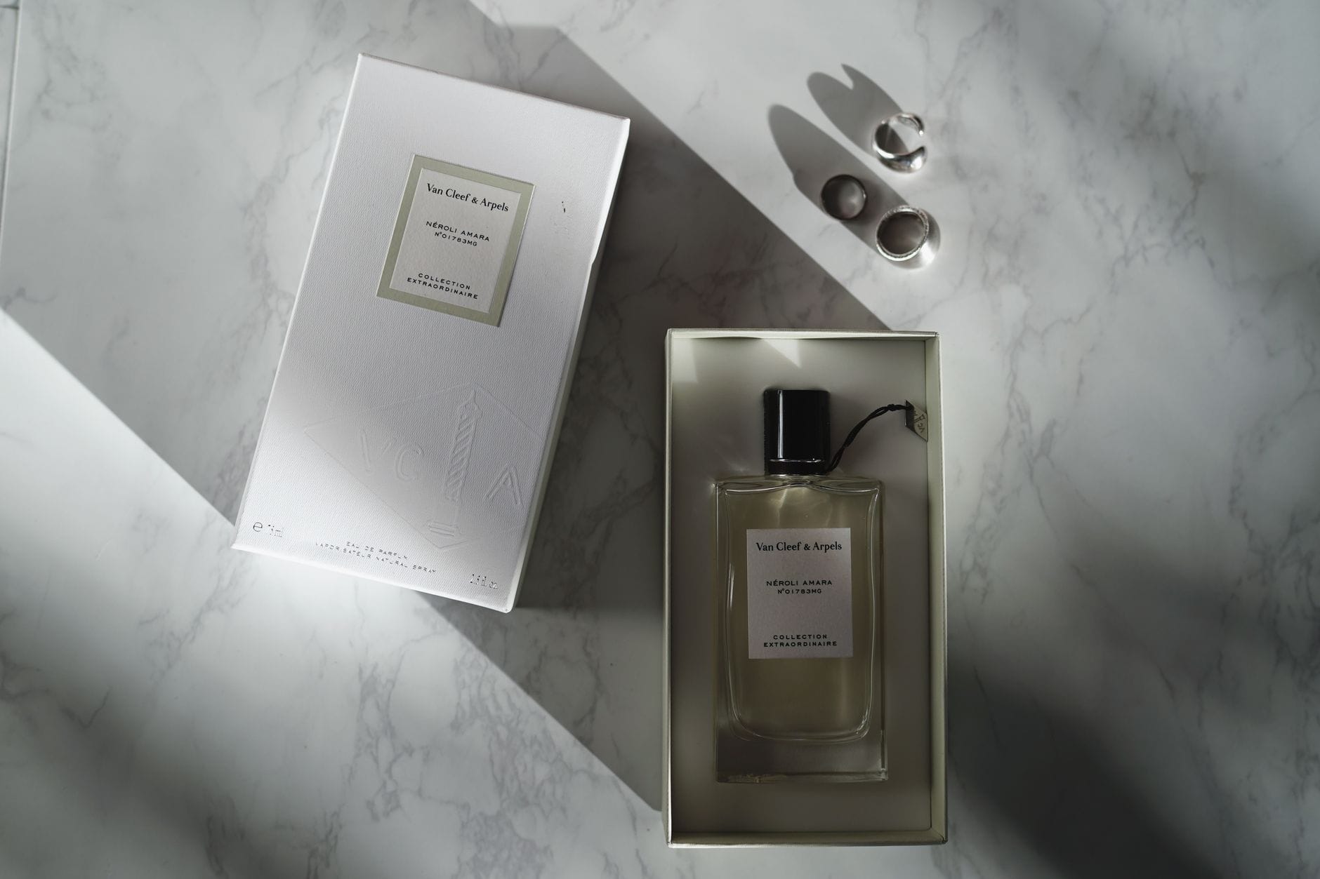 A collection of luxury niche perfume bottles from top brands displayed on an elegant marble surface.