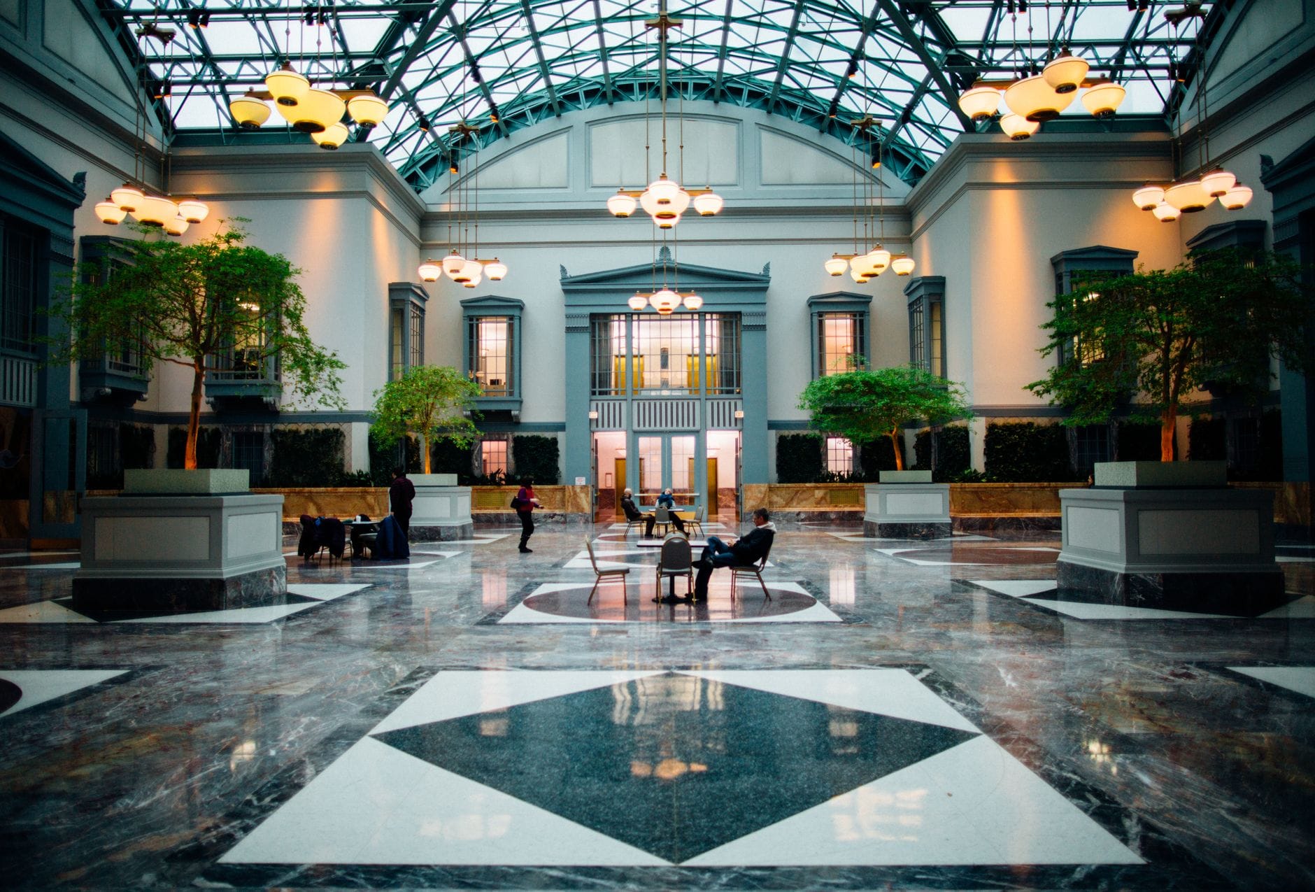 A luxury hotel lobby atmosphere paired with a high-end perfume bottle, representing scents that smell like five-star hotels.