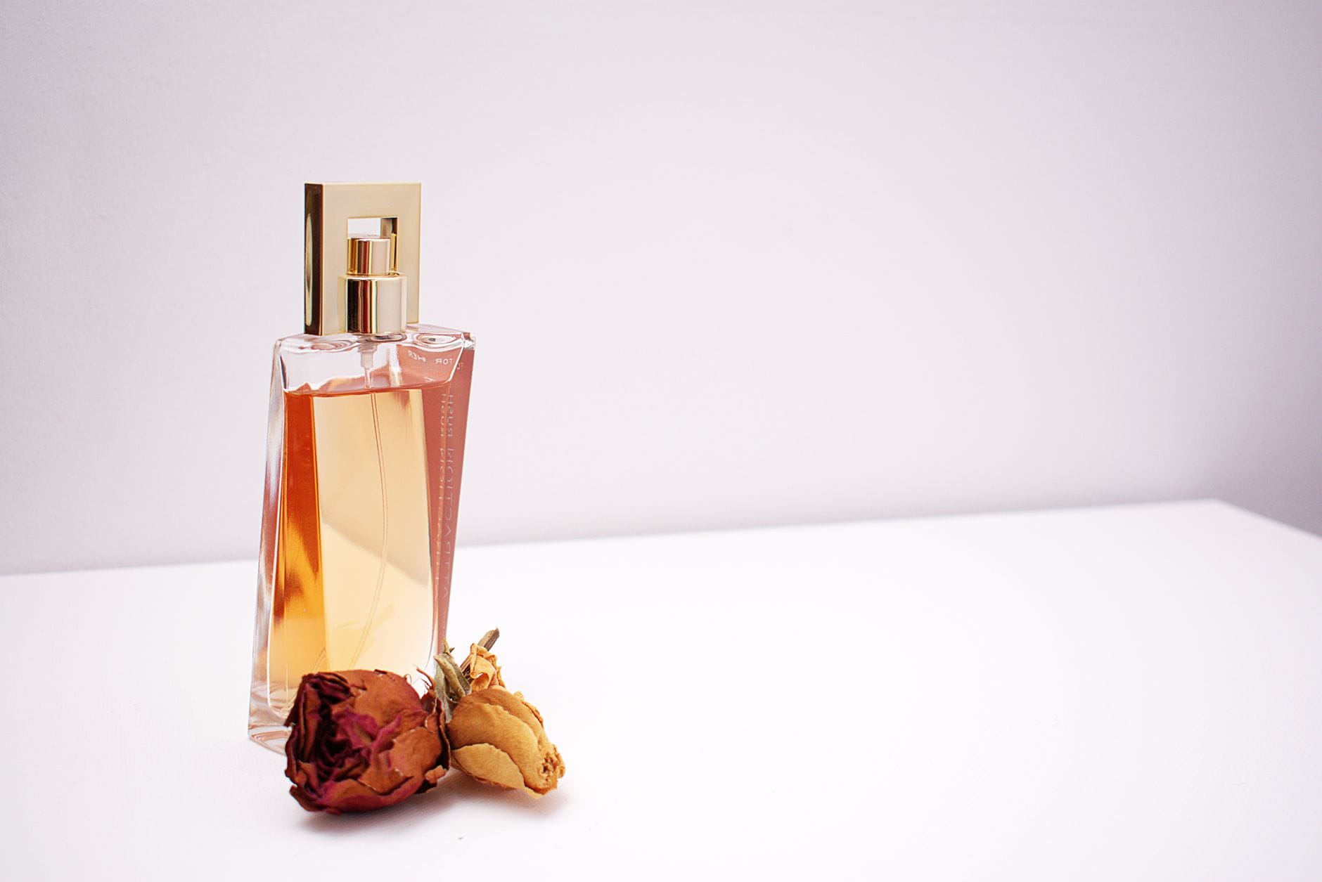 Minimalist perfume bottle on clean white linen representing the clean girl perfume aesthetic