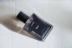 A collection of luxury men's cologne bottles on a wooden surface, representing the best signature scents for men in 2026.