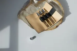 A collection of sleek, colorful travel-sized perfume subscription decants arranged on a modern vanity table.