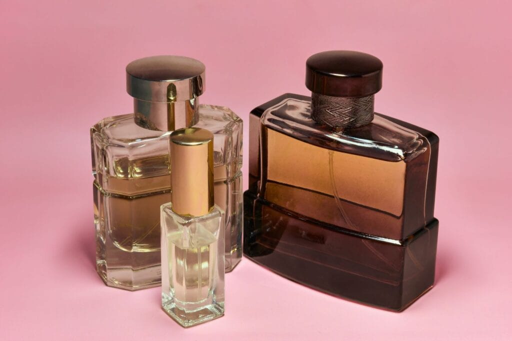 A curated collection of luxury perfume bottles on an elegant vanity table, representing the best signature scents for women in 2026.