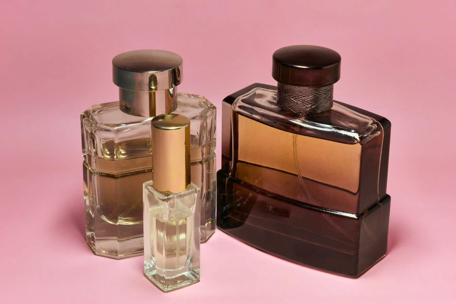 A curated collection of luxury perfume bottles on an elegant vanity table, representing the best signature scents for women in 2026.